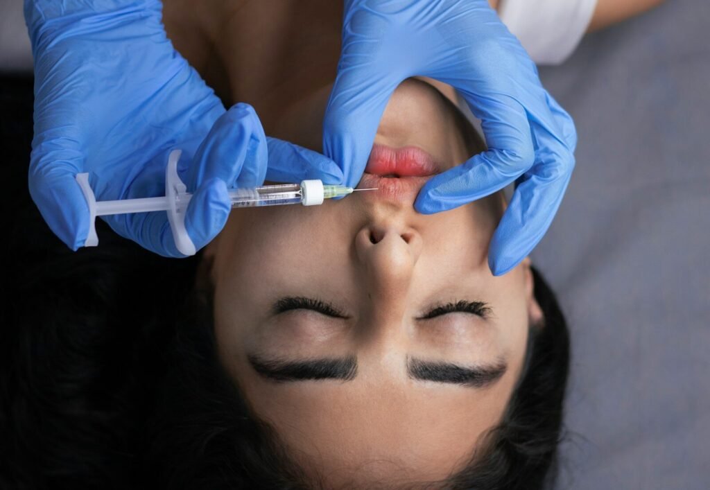 Lips receive an injection of filler.